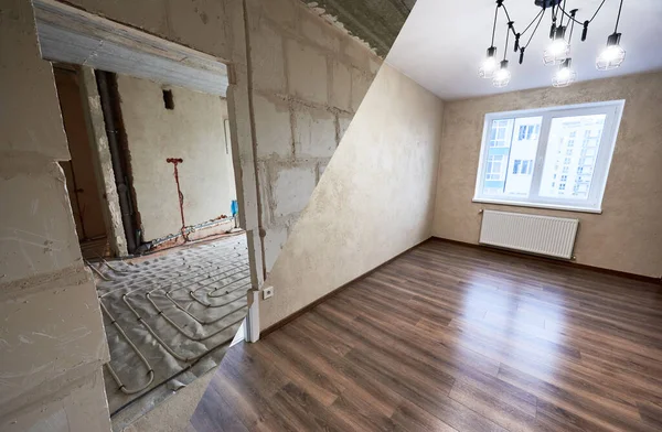 Comparison of room in apartment before and after renovation. Spacious light room with modern wood laminate and chandelier vs empty doorway with a view to another unfinished room. Construction concept