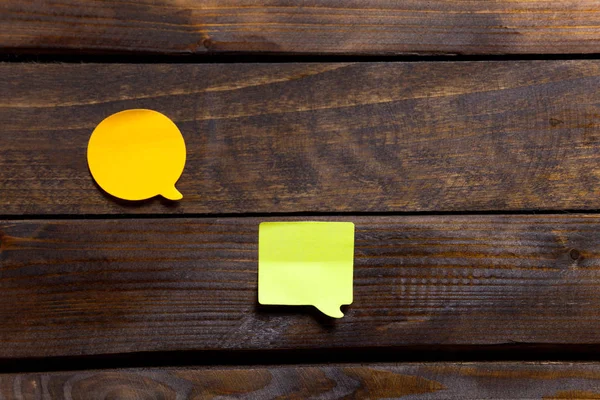 Two yellow stickers for notes and reminders on wooden background — Stock Photo, Image