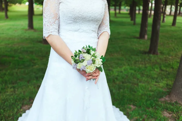Beautiful bride in white wedding dress holding bouquet — Stock Photo, Image