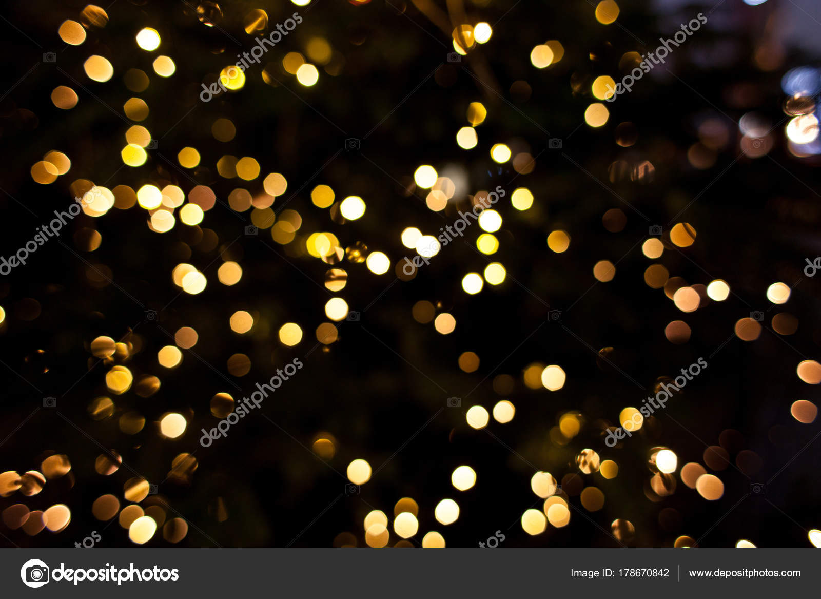 Yellow lights of a tree garland. Abstract blurred Christmas background