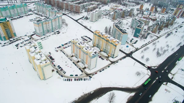 Winter city from a height. Photo taken by quadrocopter. Large tall buildings and road — Stock Photo, Image