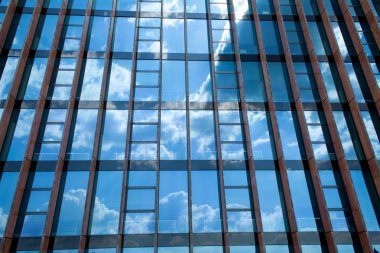 Mavi gökyüzünün yansıması ile bina büyük bir cam. Mavi arka plan. Güneşli bir günde ofis.