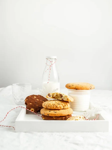 Selectarea cookie-urilor de casă, lapte, decor de iarnă pe tava de lemn pe fundal alb — Fotografie, imagine de stoc