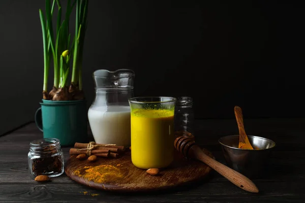 Vegansk Gurkmeja Latte Ett Glas Mandelmjölk Kryddor Krukväxter Gula Duffodils — Stockfoto