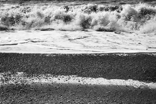 Black and White Waves Peebles Reynisfjara Black Sand Beach South Shore Iceland.  Sand is black obsidian