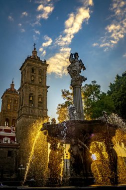 Zocalo Park Plaza San Miguel Arcangel Fountain Cathedral Sunset Puebla Mexico. Cathedral built in 15 and 1600s, Fountain in 1777 clipart