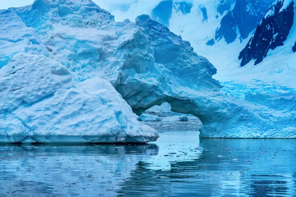 Snowing Floating Blue Iceberg Arch Reflection Mountains Paradise Bay Skintorp — Zdjęcie stockowe