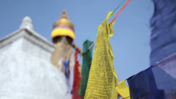 Gekleurde vlaggen vliegen in de buurt van Boudha Bouddhanath of Baudhanath stupa in Nepal — Stockvideo