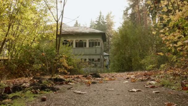 Abandoned kids camp in the forest. Autumn daytime. Smooth dolly shot — Stock Video