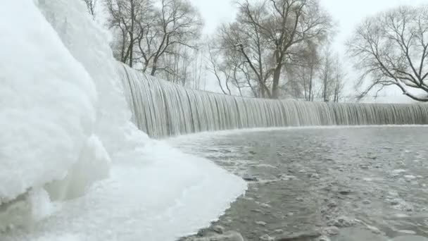 Waterfall in the winter park. Used professional gimbal stabilazer — Stock Video