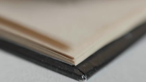 A man flips through pages in a book. Slowmotion, 180fps — Stock Video