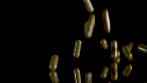 Pill capsules falling on the mirror table. Slowmotion shot, 180 fps — Stock Video