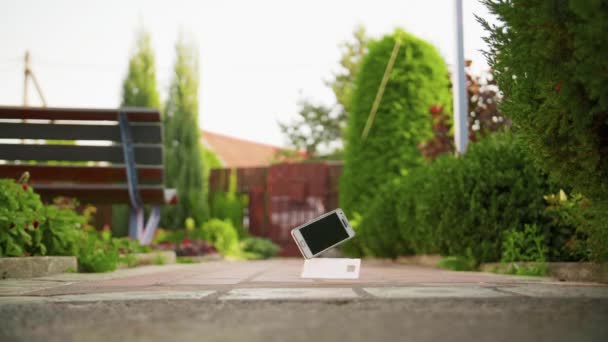 Téléphone portable tombe et casse sur le sol en béton au ralenti — Video