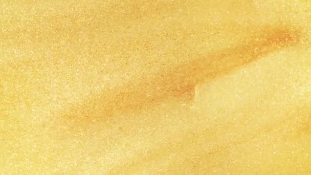 Colorful golden sand organically moves in colorful liquid in macro — 비디오