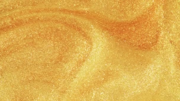 Sable doré coloré se déplace organiquement dans un liquide coloré en macro 