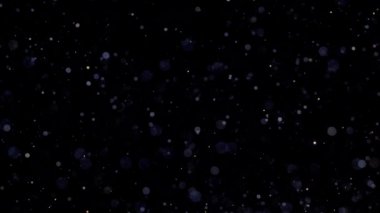 Bulanık çözünmüş bokeh ile soyut altın parçacıklar kaosu ve kar tanelerini hareket ettirir