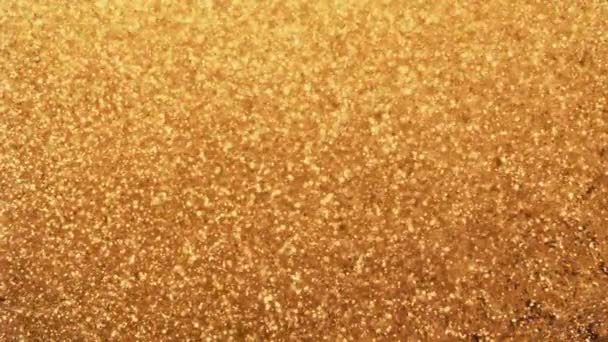 Des particules d'or abstraites avec un bokeh flou et déconcentré bouge chaos, flocons de neige — Video