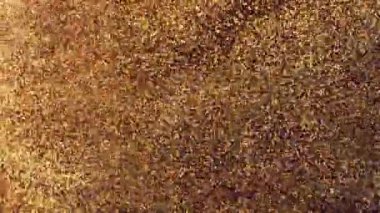 Bulanık çözünmüş bokeh ile soyut altın parçacıklar kaosu ve kar tanelerini hareket ettirir