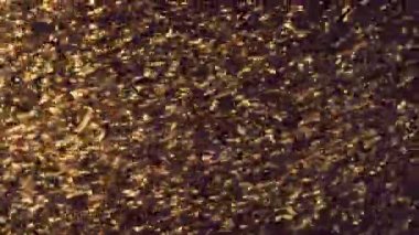 Bulanık çözünmüş bokeh ile soyut altın parçacıklar kaosu ve kar tanelerini hareket ettirir