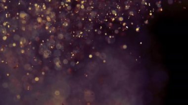 Bulanık çözünmüş bokeh ile soyut altın parçacıklar kaosu ve kar tanelerini hareket ettirir