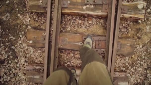 Man walks on the train rails railroad, POV top view — Stock Video