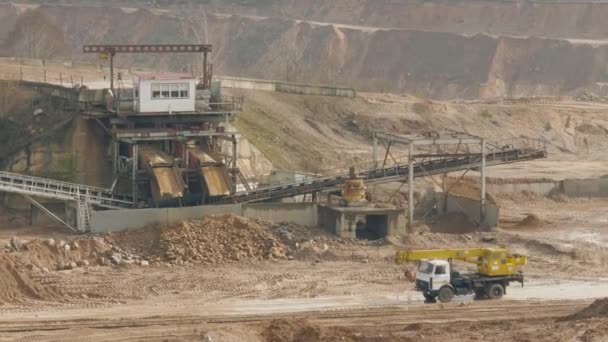 Trucks machine works in the sand ballast quarry on the cloudy summer day — Stock video