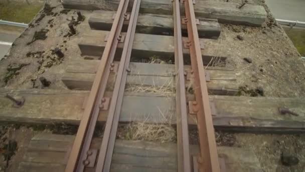 Abandoned narrow gauge railway on the bridge over raod, autumn day — Stock Video