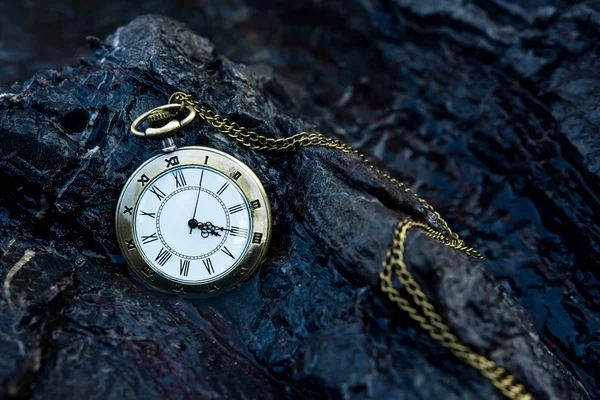 Vintage golden pocket watch on rock — Stock Photo, Image