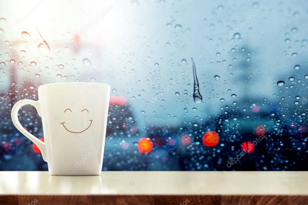 Happy Coffee Mug with smilely face on desk inside glass window, 