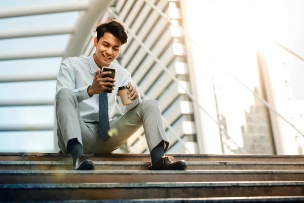 Happy Young Businessman Καθισμένος Στη Σκάλα Και Χρησιμοποιώντας Smartphone Αστικός — Φωτογραφία Αρχείου