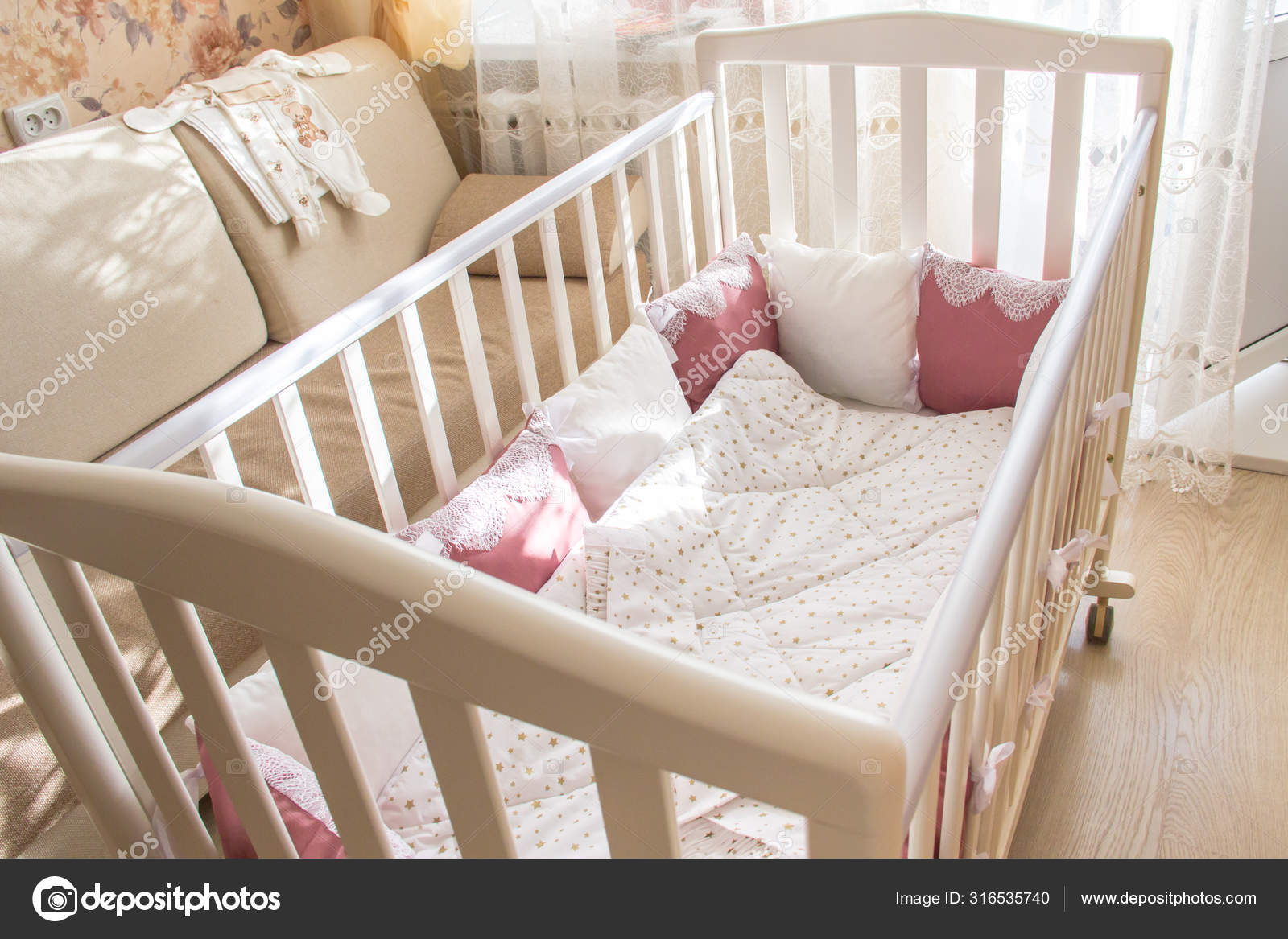 Baby bed crib with white and Burgundy color pillows with laces Stock