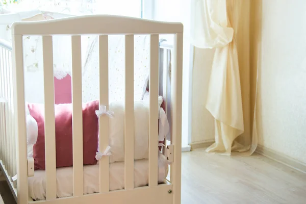 Baby bed crib with white and Burgundy color pillows with laces — Stock Photo, Image