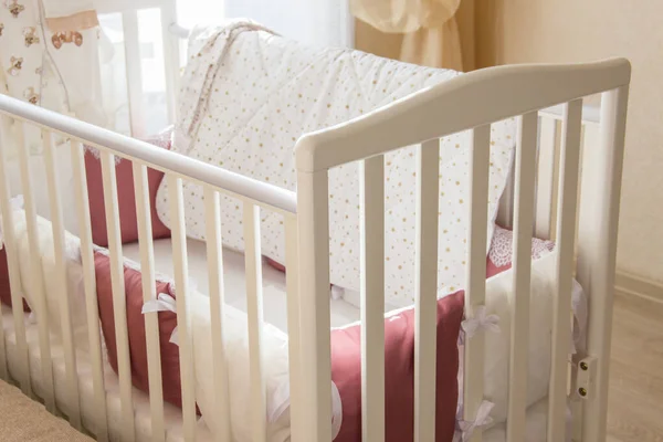 Baby bed crib with white and Burgundy color pillows with laces — Stock Photo, Image