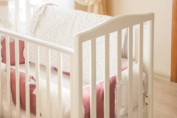 Baby bed crib with white and Burgundy color pillows with laces — Stock Photo, Image