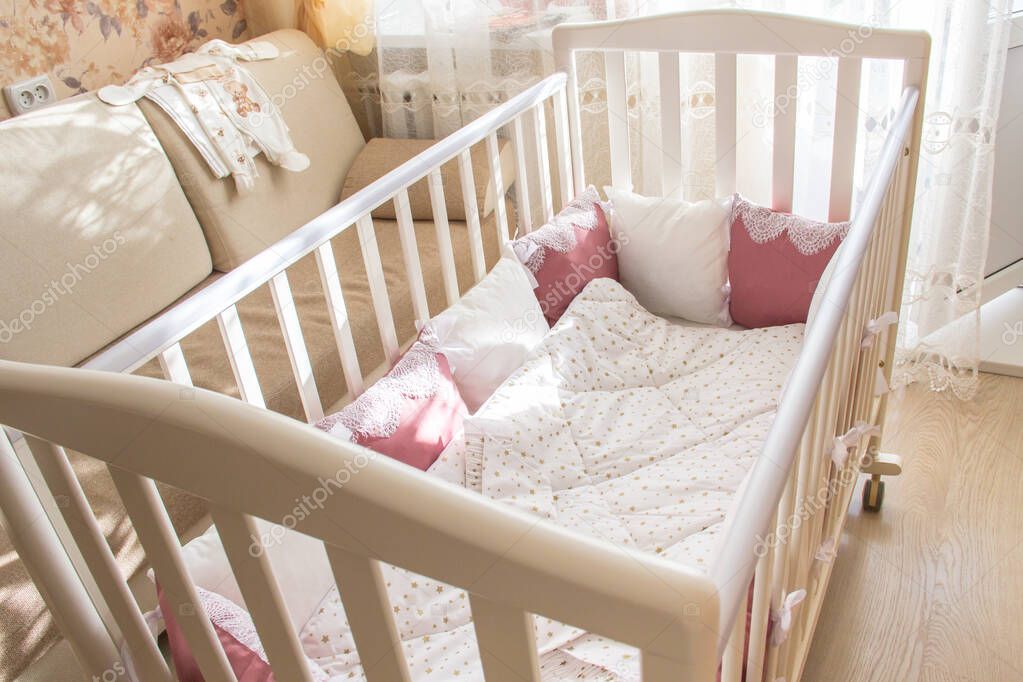 Baby bed crib with white and Burgundy color pillows with laces