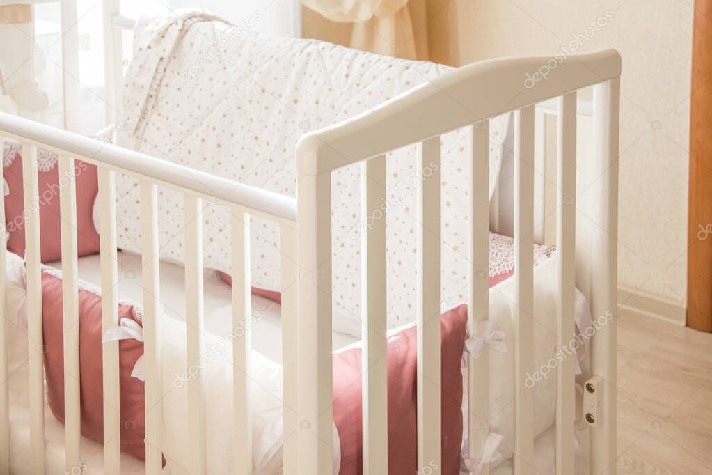 Baby bed crib with white and Burgundy color pillows with laces