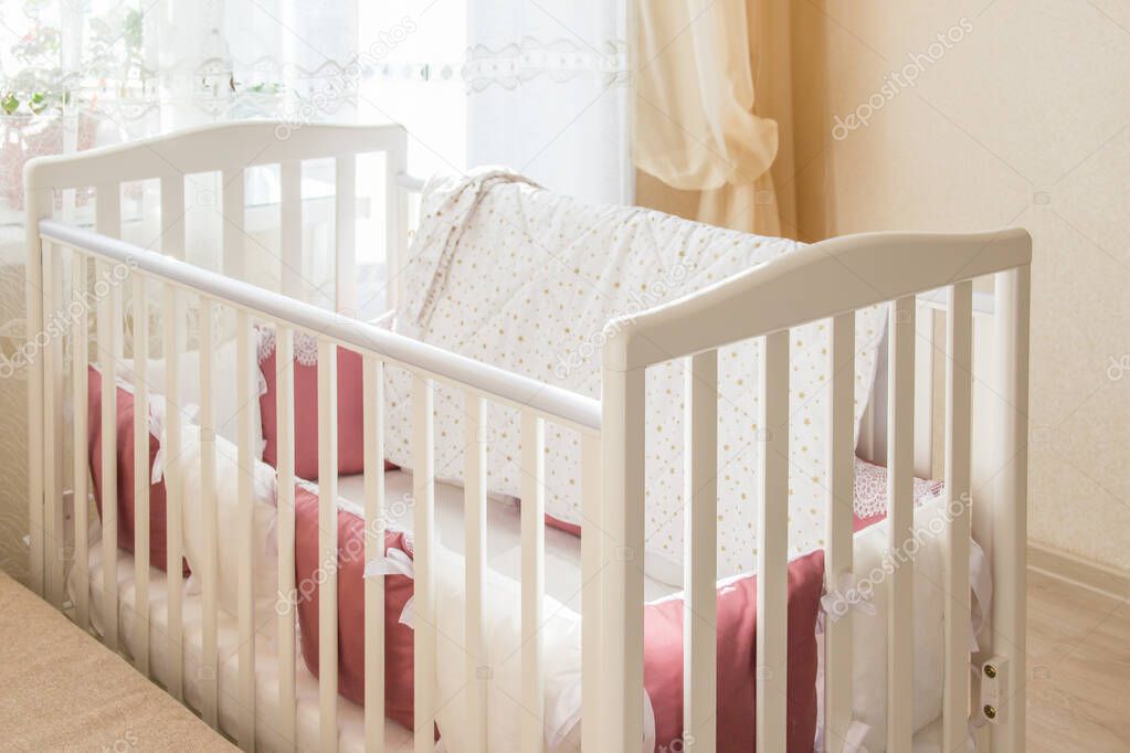 Baby bed crib with white and Burgundy color pillows with laces