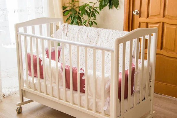 Baby bed crib with white and Burgundy color pillows with laces — Stock Photo, Image