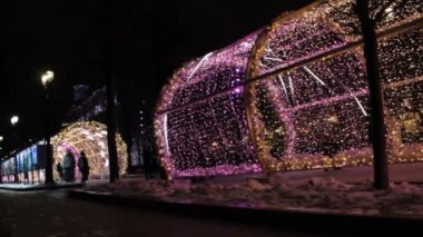 MOSCOW, Rusya - 21 Aralık 2017: renkli ışık tüneli ile aydınlanan insanlar. Sokaklar yılbaşı ve Noel tatili için süslenmiş. Kış gecesi şehirde dekorasyon ve aydınlanma.
