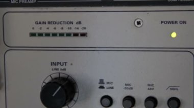 A rack of audio compressors and other components of sound reinforcement system in a recording studio close up. Signal and sound level indicators,input knob macro.Making music in a professional studio
