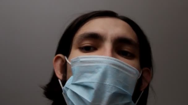 Man Wearing Surgical Face Mask Talks Looking Direct Camera Serious — Stock Video