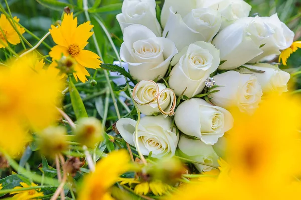 Wedding bouquet and rings in yellow flowers — Stock Photo, Image