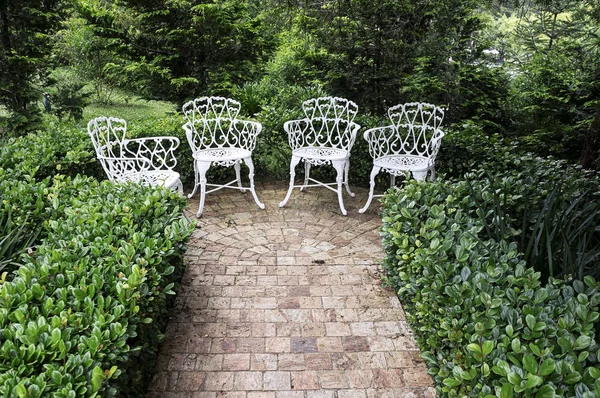 rock tiles path  end  garden chairs