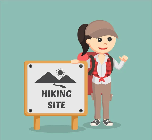 Female hiker standing beside hiking site sign — Stock Vector