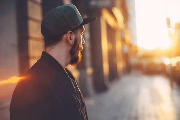 Young businessman looking in future at sunset