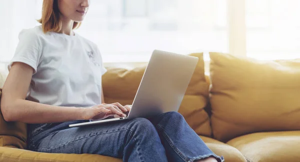 Smiling female freelancer using modern laptop while working on new project — Stock Photo, Image