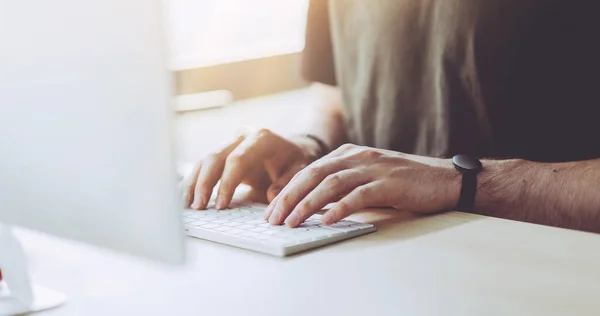 Closeup view of businessman working at sunny office on desktop computer — Stock Photo, Image