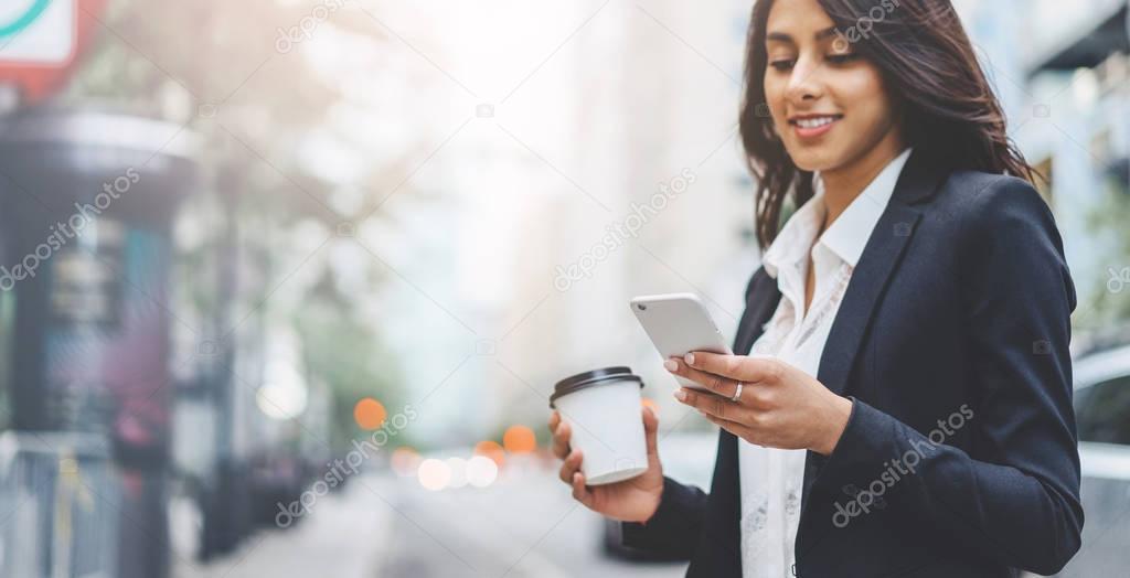 Professional business woman using technology outside