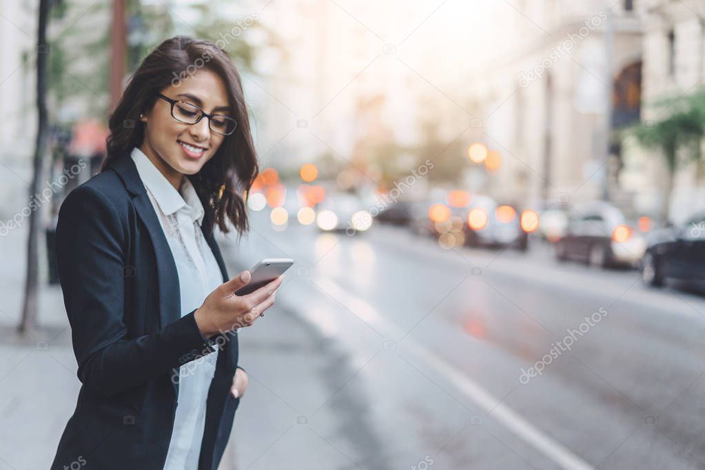 Professional business woman using technology outside to the crossroads
