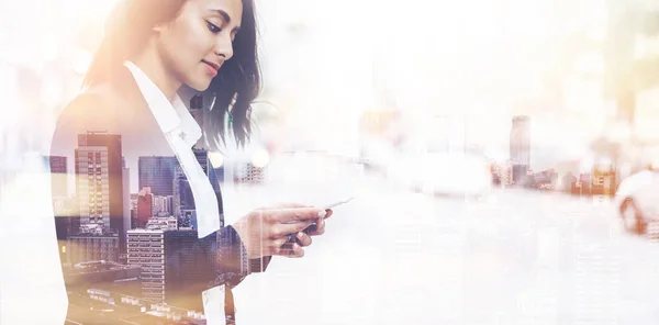 Double exposure cropped image of successful business woman wearing suit and typing message via modern smartphon — Stock Photo, Image